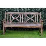 A teak garden bench with double X-framed back and slatted seat, 151cm wide x 86cm high.