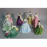 A group of eight Royal Doulton figurines, the largest 23cm high (8).