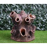 A terracotta strawberry planter of naturalistic tree trunk form, 53cm high.