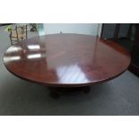 A large Regency style circular mahogany dining table, on turned column and paw feet,