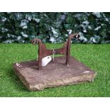 A wrought iron boot scraper on stone mount, 39cm wide x 25cm high.