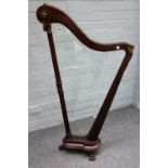 A 19th century gilt metal mounted mahogany firescreen, modelled as a harp on paw feet,