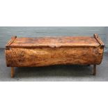 A pitch pine dug out chest on four staked supports, 128cm wide x 53cm high.