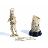 A Japanese sectional ivory okimono of a man, Meiji period,