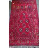 An Afghan prayer rug, 126cm x 74cm.