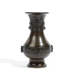 A small Chinese bronze vase, Xuande three character mark but later, of pear form,