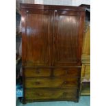 A late George III mahogany linen press with moulded panel doors over two short and two long