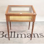 A William IV style mahogany and satinwood banded bijouterie table on fluted tapering supports,