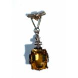 A gold and citrine single stone pendant,