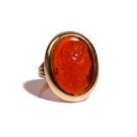 A gold and oval cornelian cameo ring, carved as the portrait of a classical lady,