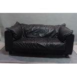 HEALS; A pair of modern hardwood framed 'Cloe' two seater low sofas with black leather upholstery,