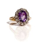 A gold, amethyst and diamond set oval cluster ring,