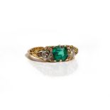 A gold, emerald and diamond ring, mounted with the square step cut emerald to the centre,