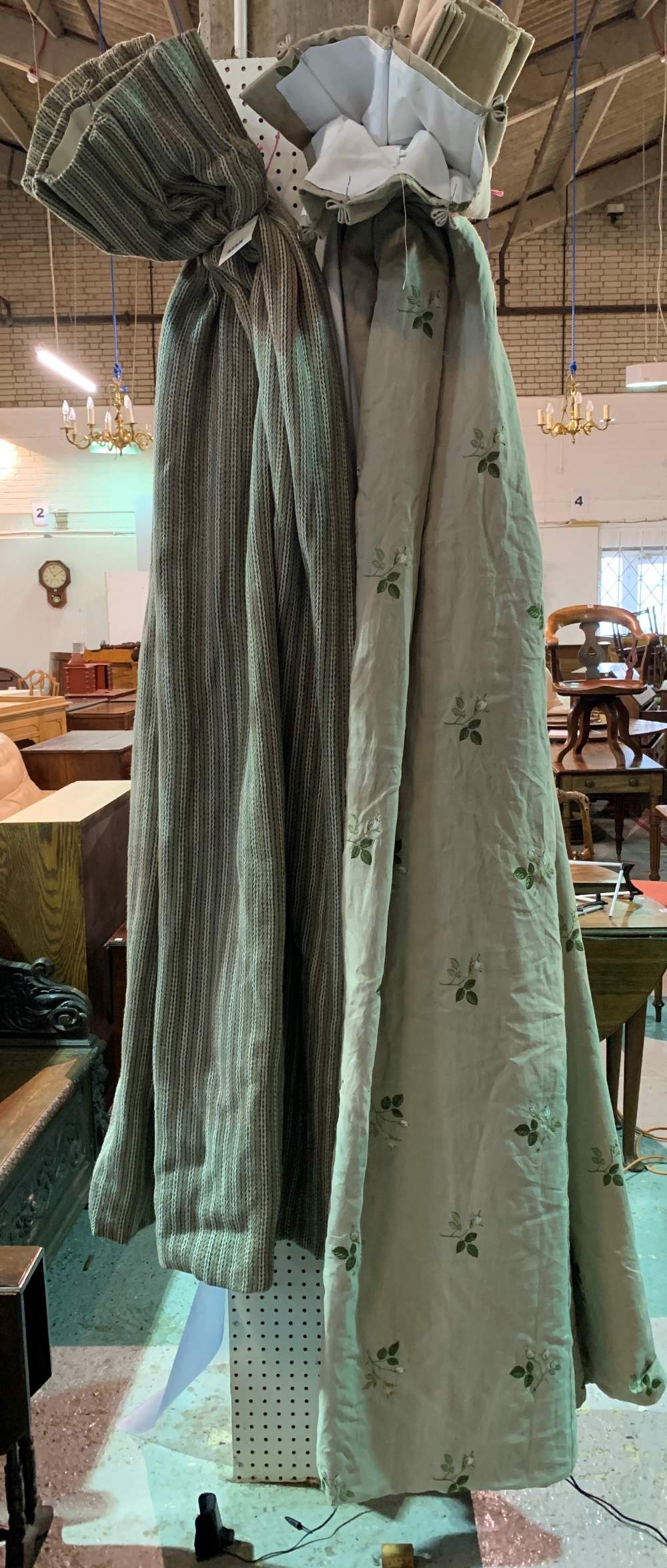 A pair of lined and interlined beige curtains embroidered with floral decoration, each