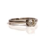 A platinum and diamond single stone ring, claw set with a circular cut diamond, ring size M,