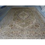 A Persian pattern carpet, machine made with a floral pattern on a green ground, 364cm x 275cm.
