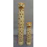 A pair of modern tall carved wooden models of leopards, the tallest 104cm tall.