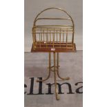 A late Victorian mahogany brass magazine rack with two divisions on tubular tripod base,