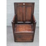 A 17th century oak lambing style chair of enclosed panel construction, 54cm wide x 98cm high.