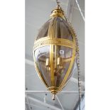 A modern gilt metal lantern of ovoid form, with glazed panels,