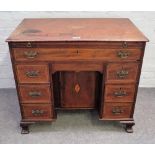 A mid-18th century inlaid mahogany kneehole writing desk with brushing slide over one long and