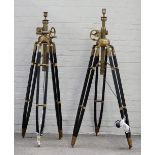 A pair of modern black painted wood and brass height adjustable tripod standard lamps,