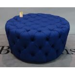 A modern hardwood framed circular footstool with blue button back upholstery, 92cm dia x 46cm high.