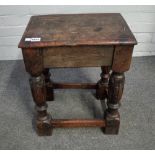 A 17th century and later oak joint stool on fluted baluster supports united by perimeter stretcher,