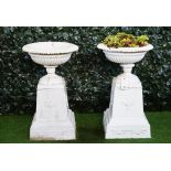A pair of white painted cast iron campana shape terrace urns, late 19th century,
