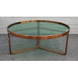 20th century design; a modern lacquered brass circular coffee table, with glass inset top,