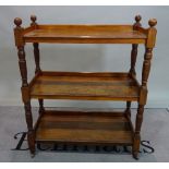 A Victorian walnut three tier buffet, on ring turned baluster supports, 89cm wide x 111cm high.