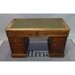 A late 19th century oak pedestal desk with inset leather top over eight drawers,