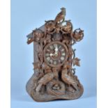 A German carved fruitwood 'Cuckoo' clock By Beha, Late 19th Century With carved cresting piece,