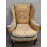 A George II wingback easy armchair with bow seat on shell capped pad supports,