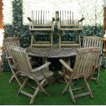 A teak circular garden table of slatted construction, 130cm diameter,