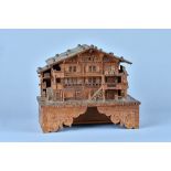 A charming Swiss fruitwood and softwood musical box in the form of a chalet Circa 1896 The musical