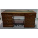 A modern burr walnut desk with inset leather top,