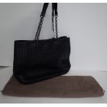 A Bottega Veneta black woven leather tote bag, with two chain and black leather straps,