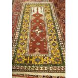 A Turkish prayer rug, the brown mehrab with a diamond to centre,