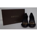 A pair of lady's Gucci black leather high heeled court shoes with gold-tone hardware G buckles,