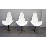 In the manner of Arne Jacobson; a set of three cream leather upholstered dining chairs,