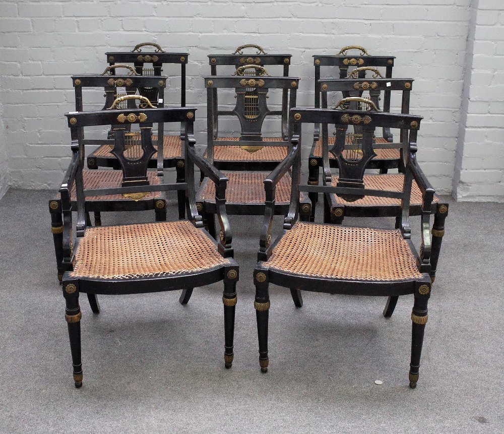 A set of eight Regency gilt metal mounted ebonised cane seat dining chairs on tapering turned