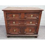 A 17th century oak chest with three long geometric moulded drawers on stile feet,