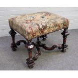 A 17th century style walnut framed rectangular footstool, on square baluster supports,