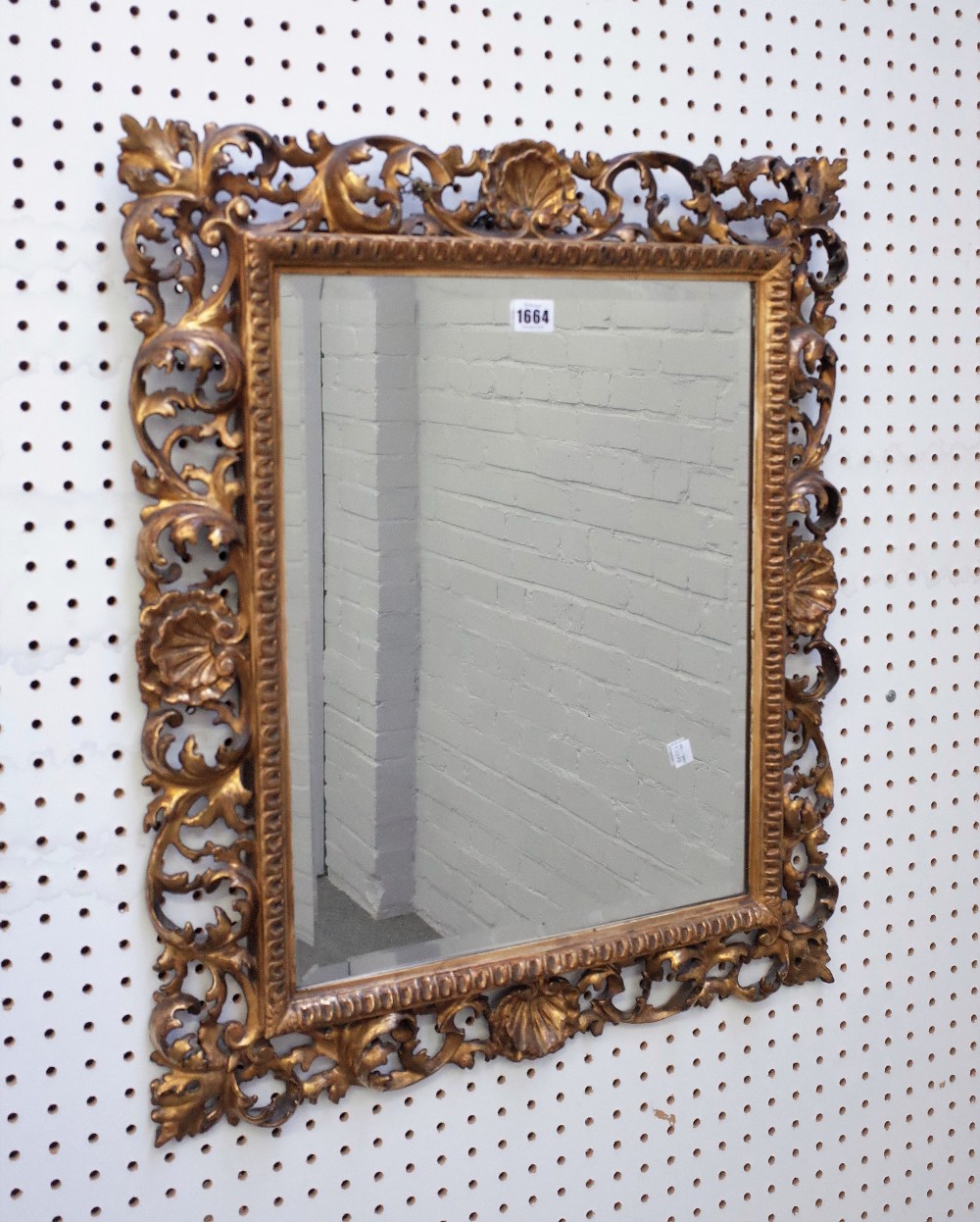 A Florentine gilt framed mirror with shell and acanthus chased frame and bevelled mirror plate,