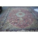 A machine made carpet of Persian design, 397cm x 304cm.