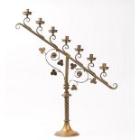 A pair of early 20th century brass seven branch candelabra, with scroll-work decoration,