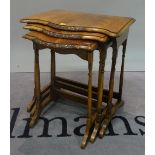 A Victorian style walnut nest of three tables, the largest 54cm wide x 57cm high.