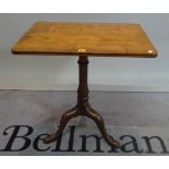 A 19th century mahogany tripod table with turned column on downswept supports,