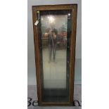 An early 20th century hardwood floor standing display cabinet with mirrored back,